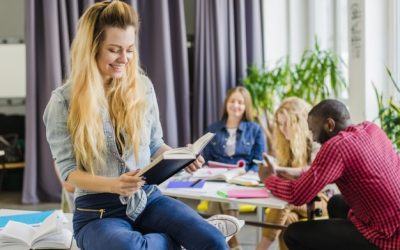 cheerful-woman-with-book-classroom_23-2147656372