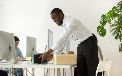 happy-african-new-employee-unpacking-belongings-first-working-day_1163-5136