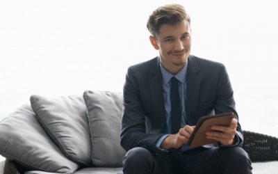 smiling-successful-young-man-using-tablet-computer_1262-2004